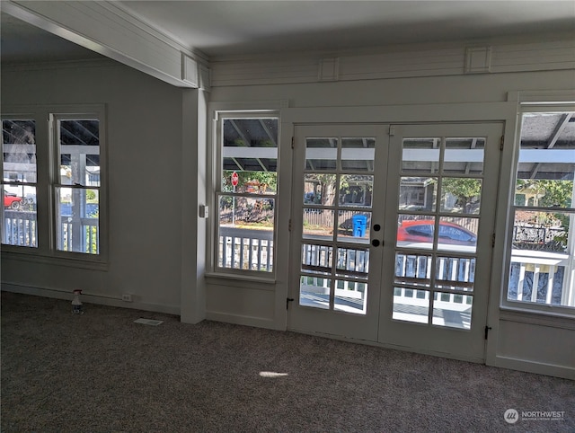 entryway featuring a wealth of natural light, french doors, and carpet floors