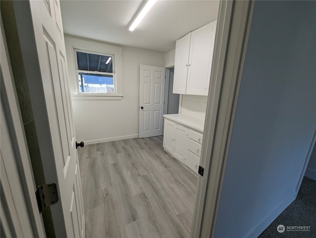 laundry room featuring light hardwood / wood-style flooring