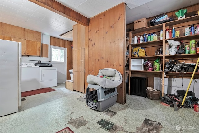 interior space featuring wooden walls and washer and clothes dryer