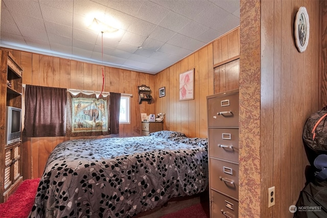 bedroom featuring wooden walls