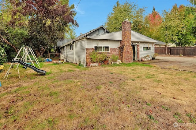 exterior space featuring a lawn and a playground