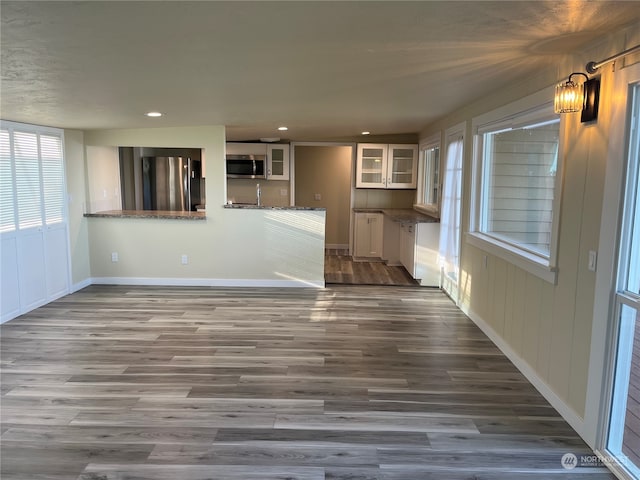 unfurnished living room featuring hardwood / wood-style flooring