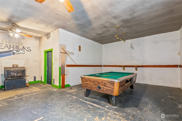 rec room with pool table, a wood stove, and ceiling fan