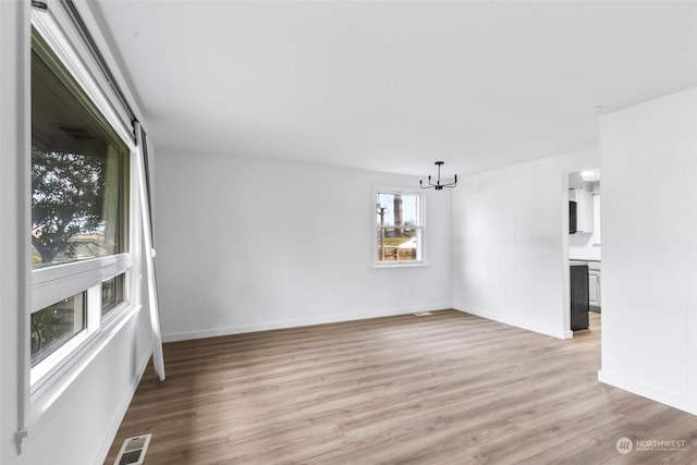 interior space featuring a chandelier and light hardwood / wood-style flooring