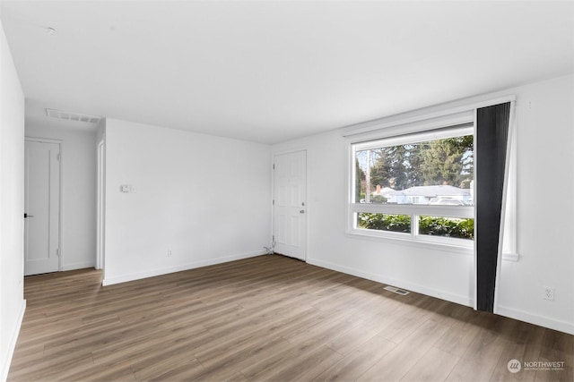 unfurnished room with wood-type flooring