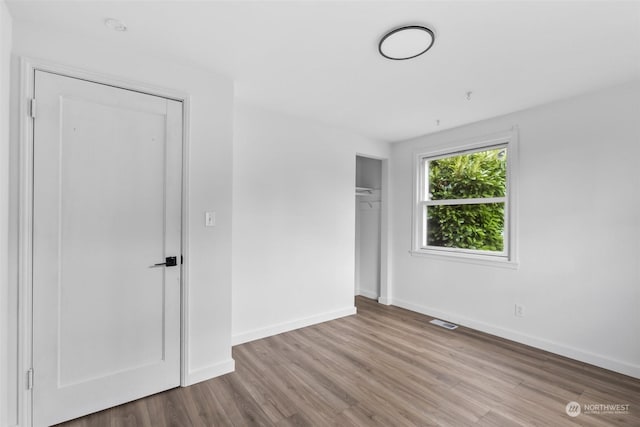 unfurnished bedroom with light wood-type flooring