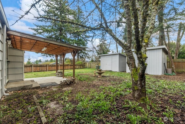 view of yard with a storage shed and a patio area