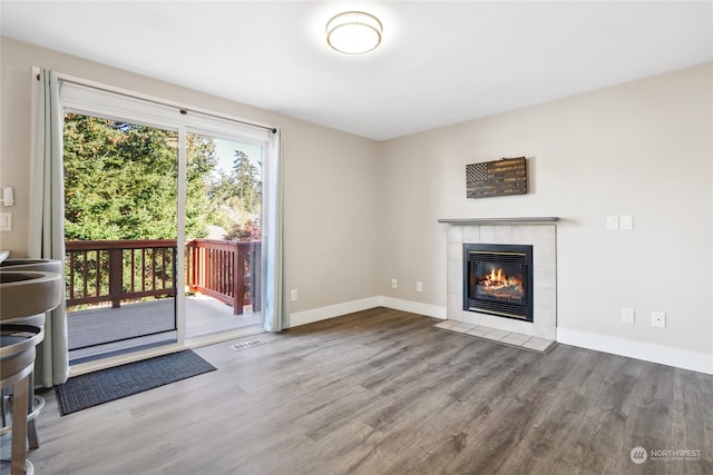 unfurnished living room featuring a fireplace and wood-type flooring