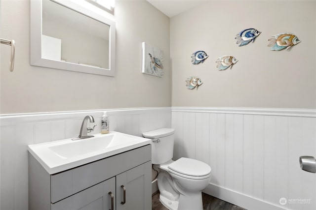 bathroom featuring hardwood / wood-style flooring, vanity, and toilet