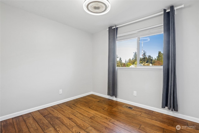 unfurnished room featuring hardwood / wood-style floors