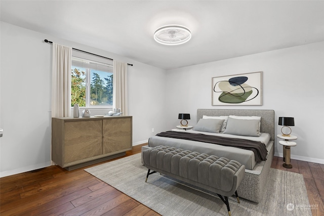 bedroom with dark hardwood / wood-style flooring