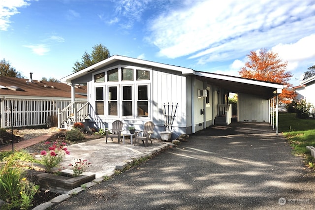 back of house featuring a carport