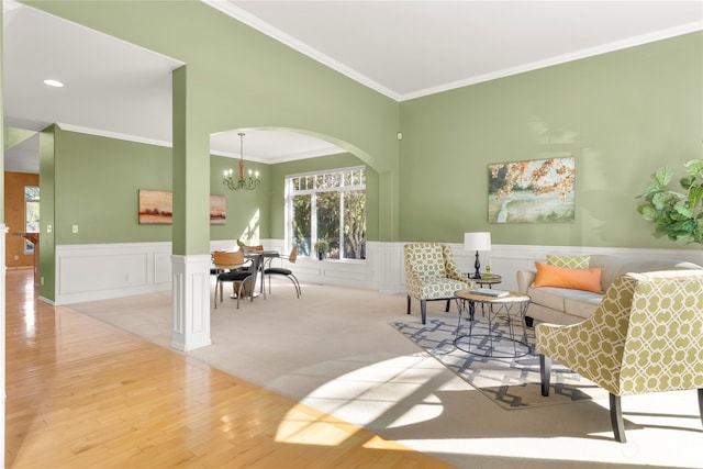 sitting room featuring light carpet, a chandelier, and ornamental molding