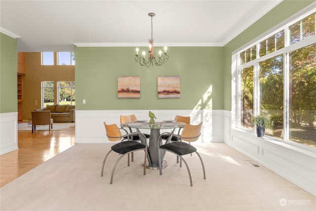 carpeted dining space featuring a notable chandelier and crown molding