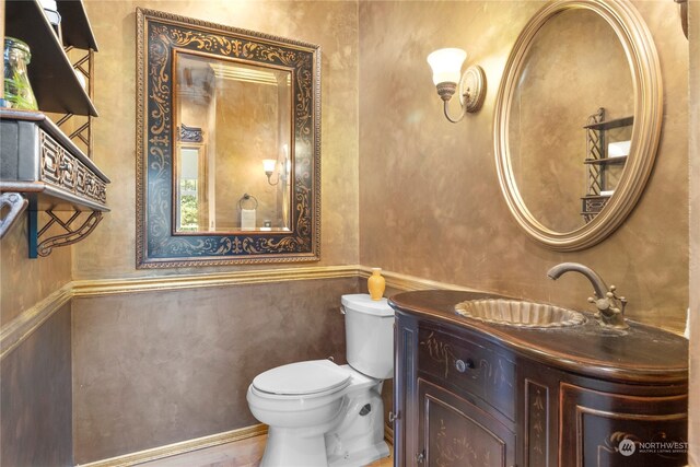 bathroom featuring toilet and vanity