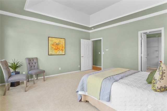 bedroom with crown molding, ensuite bath, carpet flooring, and a tray ceiling