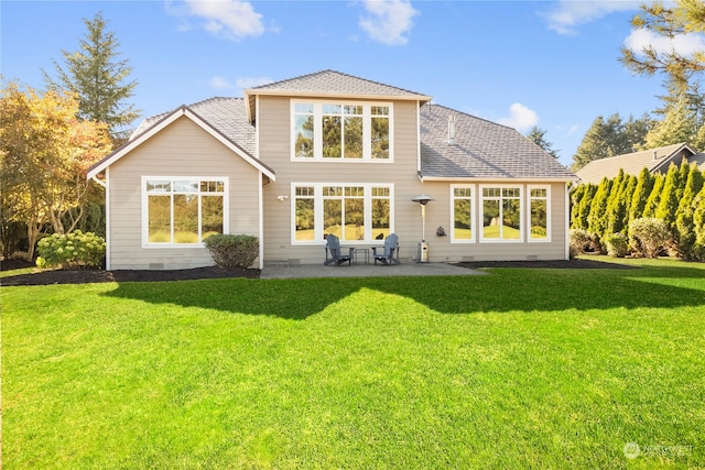 rear view of house featuring a patio area and a yard