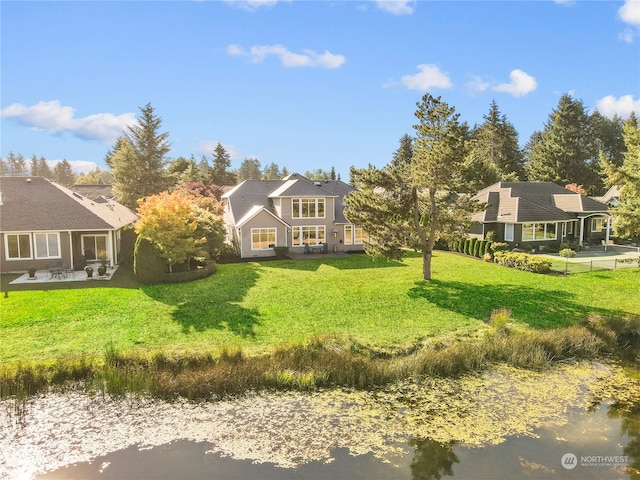 view of front of property with a front yard and a water view