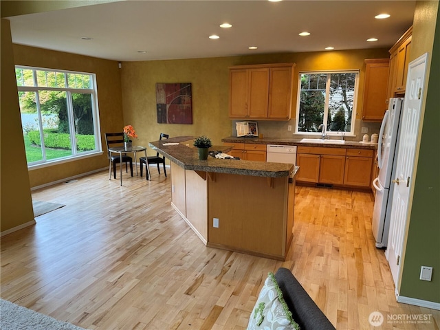 6036 Troon Ln SE, Olympia, WA 98501 - kitchen with white appliances, light wood finished floors, plenty of natural light, a sink, and recessed lighting