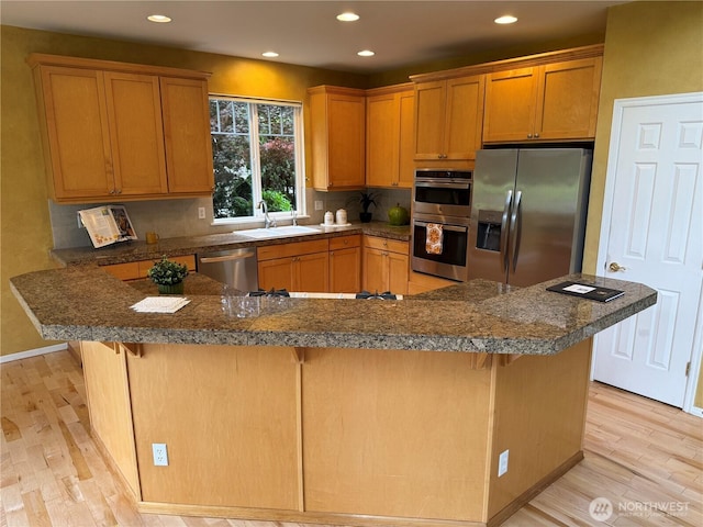 6036 Troon Ln SE, Olympia, WA 98501 - kitchen with stainless steel appliances, a sink, light wood-type flooring, recessed lighting, and tasteful backsplash