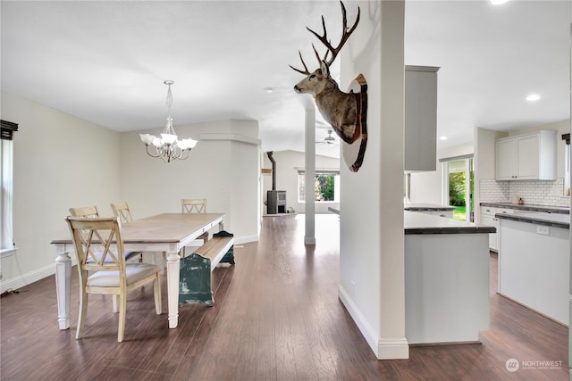 dining space with an inviting chandelier and dark wood-type flooring