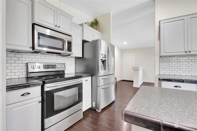 kitchen featuring backsplash, dark wood-type flooring, white cabinets, and stainless steel appliances