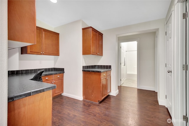 kitchen with dark hardwood / wood-style flooring