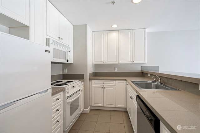 kitchen with white appliances, white cabinetry, light tile patterned flooring, and sink