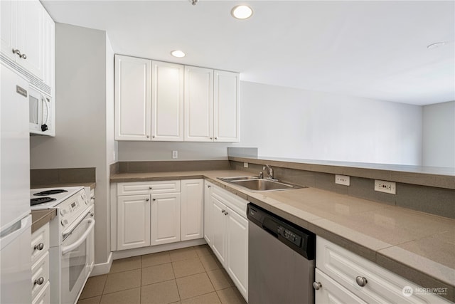 kitchen with light tile patterned flooring, sink, white appliances, and white cabinetry