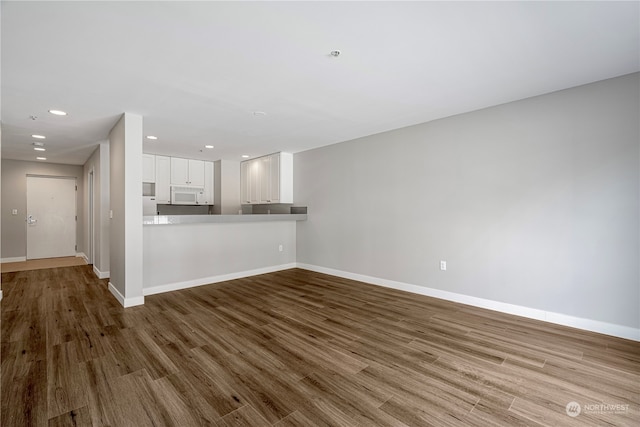 unfurnished living room featuring hardwood / wood-style flooring