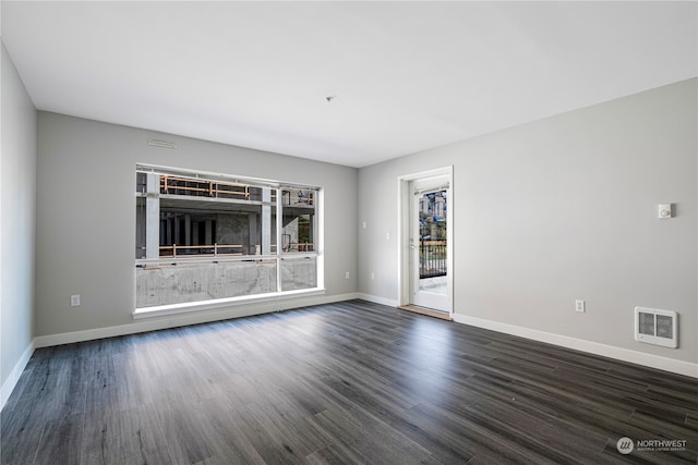 unfurnished living room featuring dark wood-type flooring