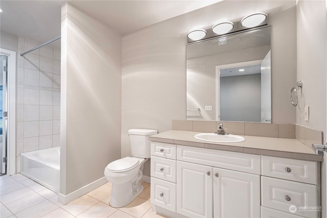 full bathroom with tiled shower / bath, vanity, toilet, and tile patterned floors