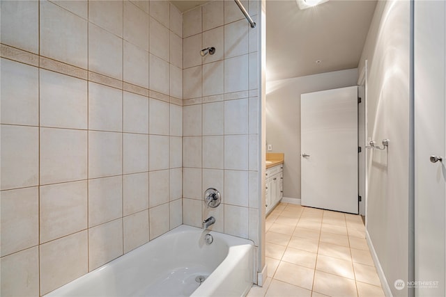 bathroom featuring tile patterned flooring, vanity, and tiled shower / bath