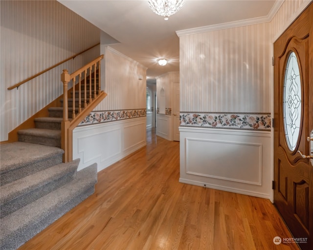 entryway featuring light hardwood / wood-style flooring and ornamental molding