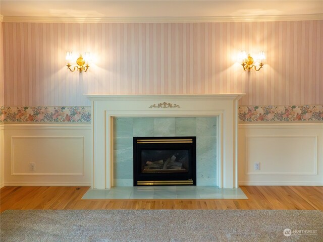 interior details with ornamental molding, a fireplace, and wood-type flooring