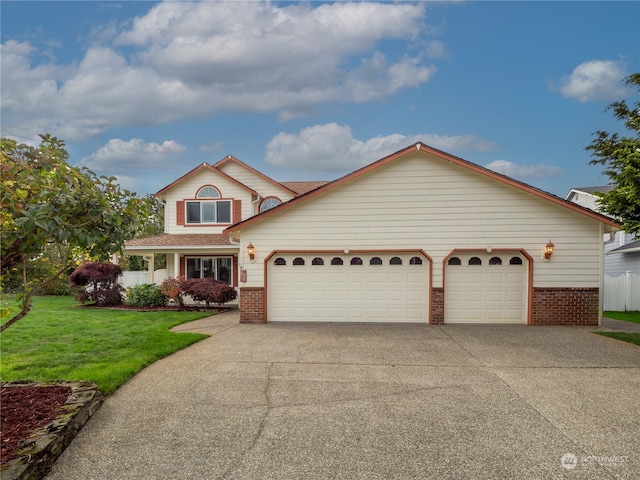 front of property with a front yard and a garage