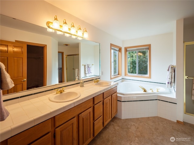 bathroom with vanity, independent shower and bath, and tile patterned floors