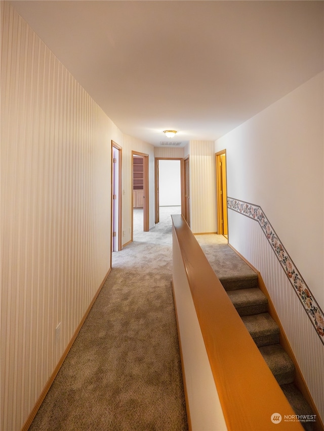 corridor with light colored carpet