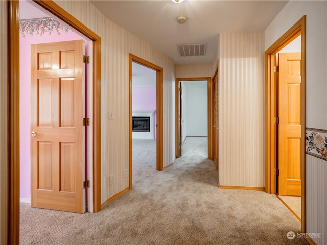 hall with light colored carpet