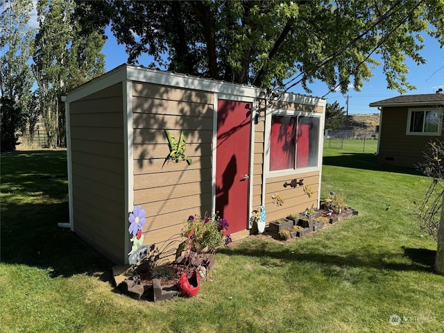 view of outdoor structure with a lawn