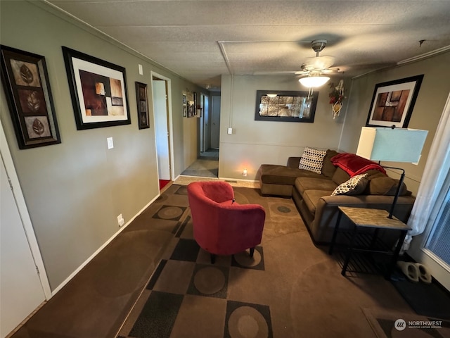 living room featuring ceiling fan and a textured ceiling