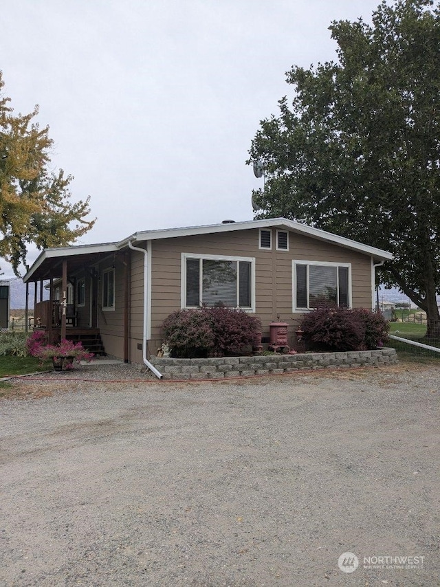 view of side of home with a porch