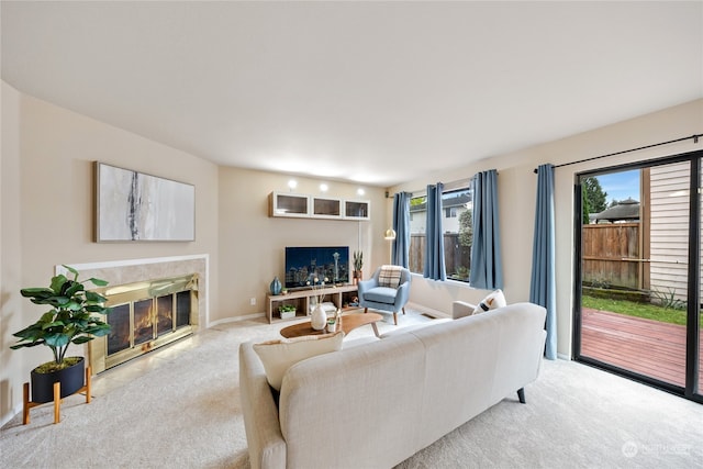 carpeted living room with a premium fireplace