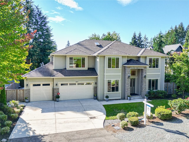 view of front of home with a garage and a front yard