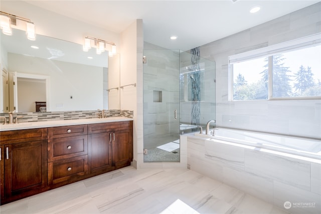 bathroom with shower with separate bathtub and vanity