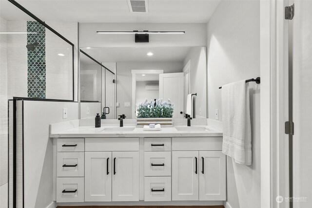 bathroom featuring walk in shower, a wall unit AC, and vanity