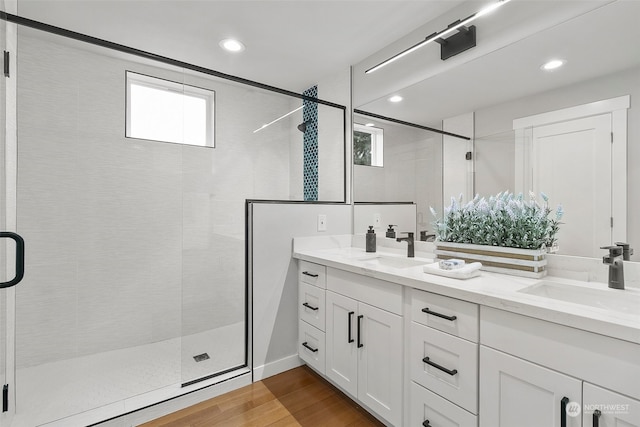 bathroom with vanity, hardwood / wood-style floors, and a shower with shower door