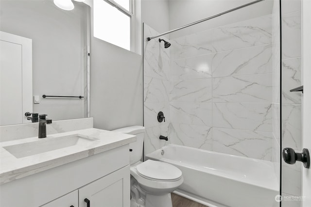 full bathroom with hardwood / wood-style flooring, vanity, toilet, and tiled shower / bath combo