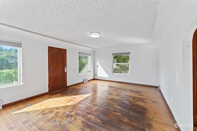 entrance foyer with wood-type flooring and a textured ceiling