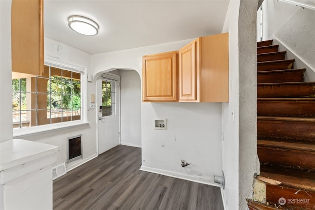 washroom featuring cabinets, hookup for a washing machine, and dark hardwood / wood-style flooring